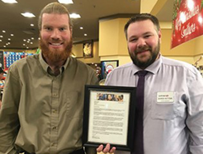 Staff from Smithers Safeway stand and hold the letter of recognition from the North Council.